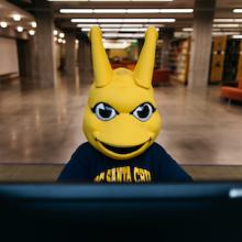 Sammy Slug Mascot at computer
