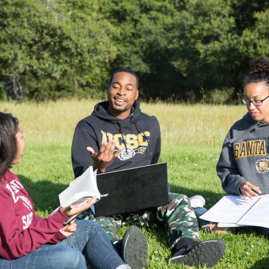 Students talking in Oakes field
