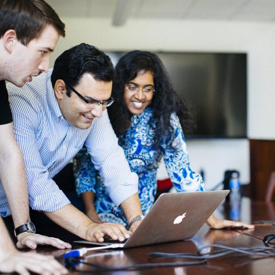 People looking at a laptop