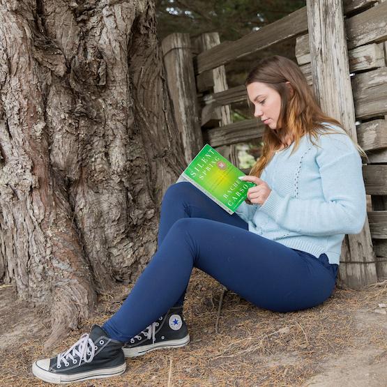 Student reading outdoors