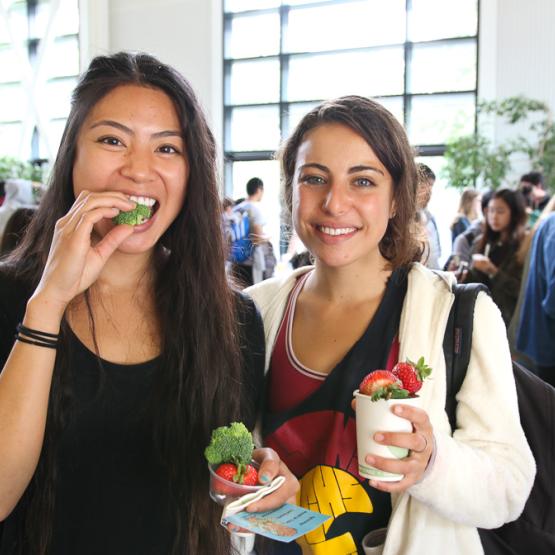 Two students eating strawberries