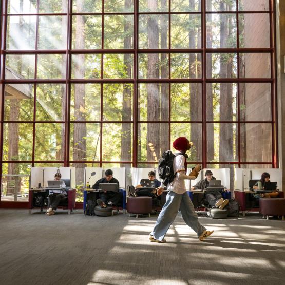 student walking through a library