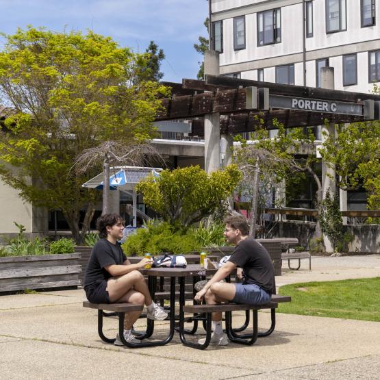 students sitting at an outside table at Porter College