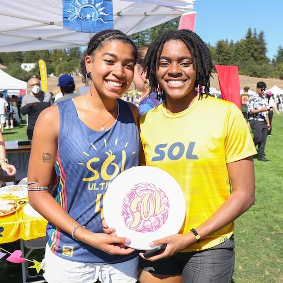 Two students representing a student org at the Cornucopia Fair